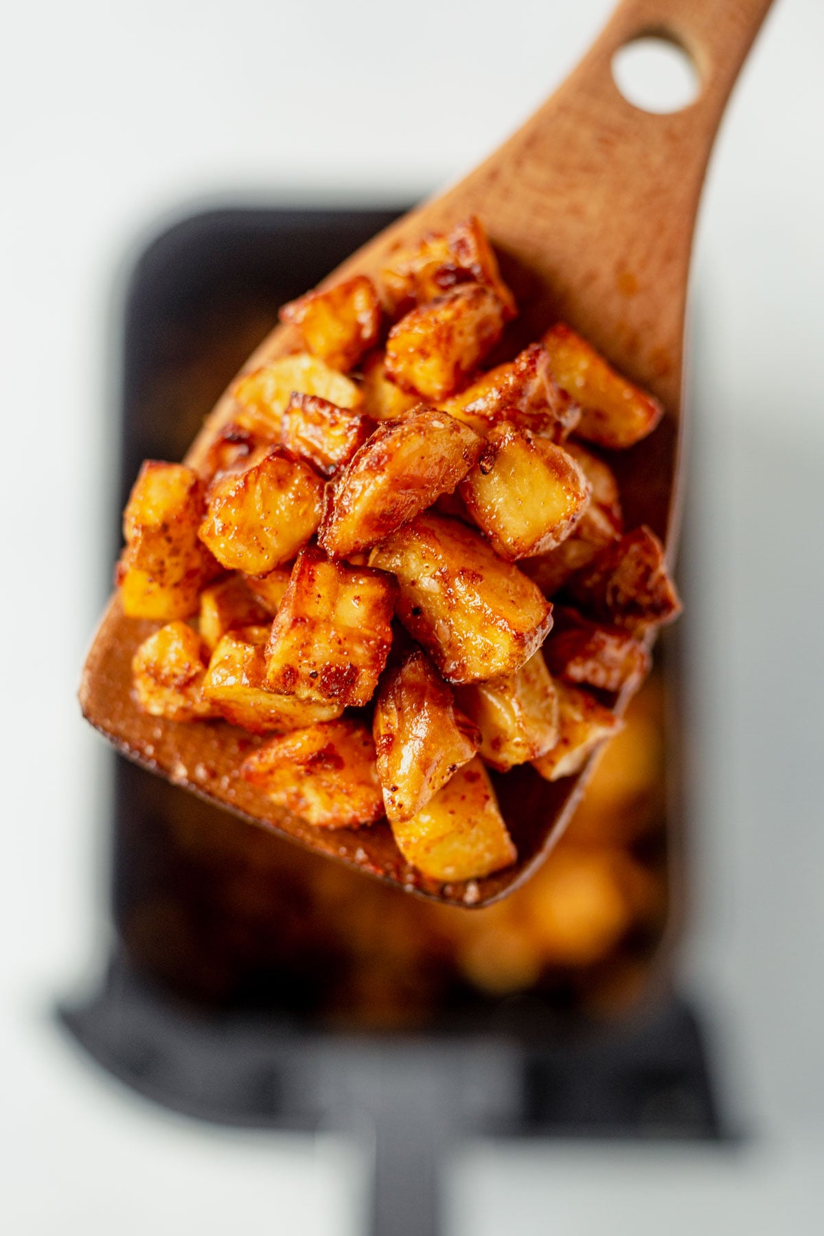 wooden spoon with air fryer breakfast potatoes