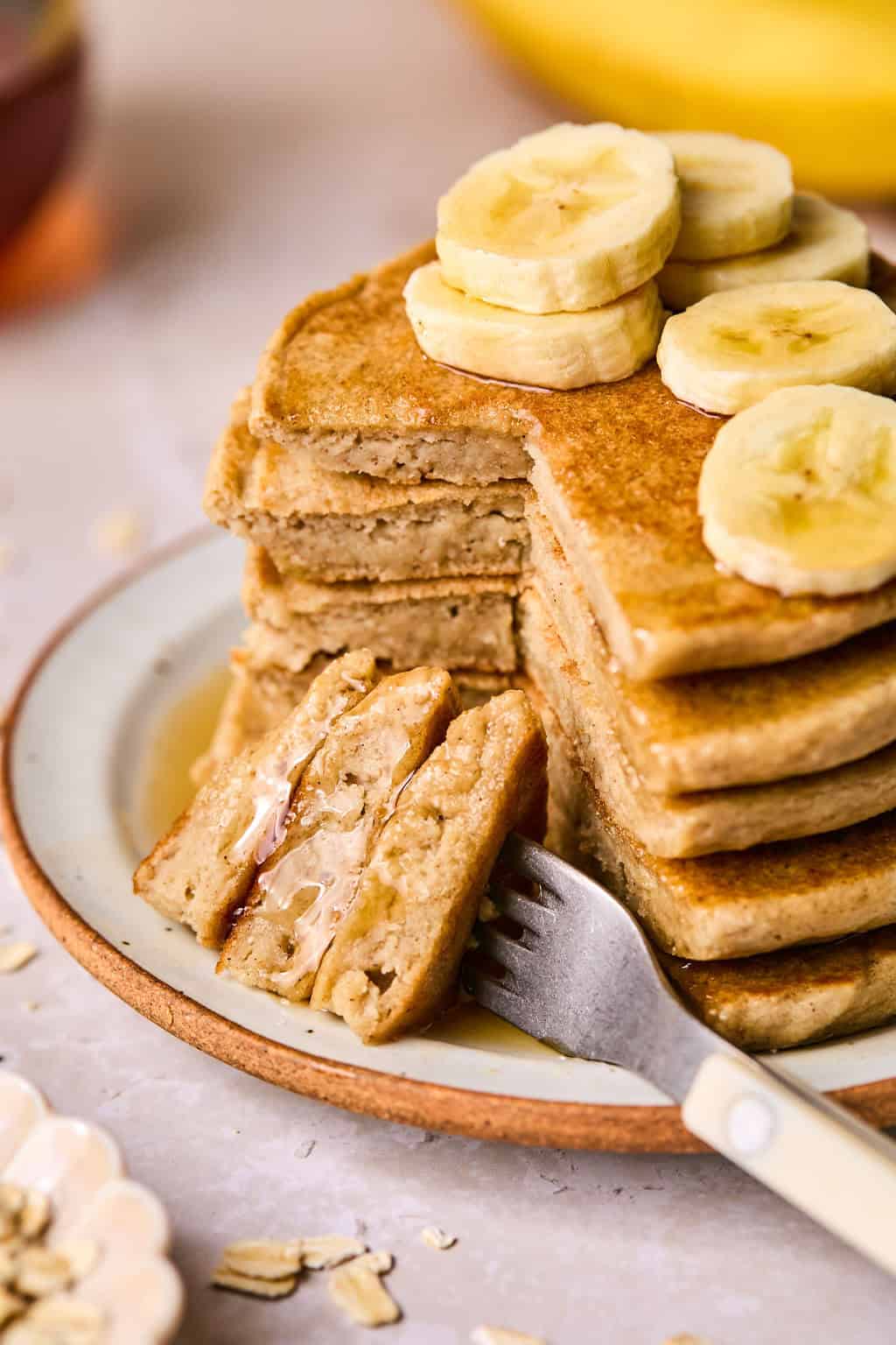 a stack of banana oat pancakes on a plate.