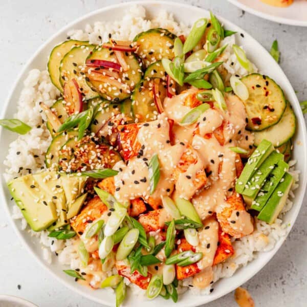 bang bang salmon rice bowl with cucumber and avocado