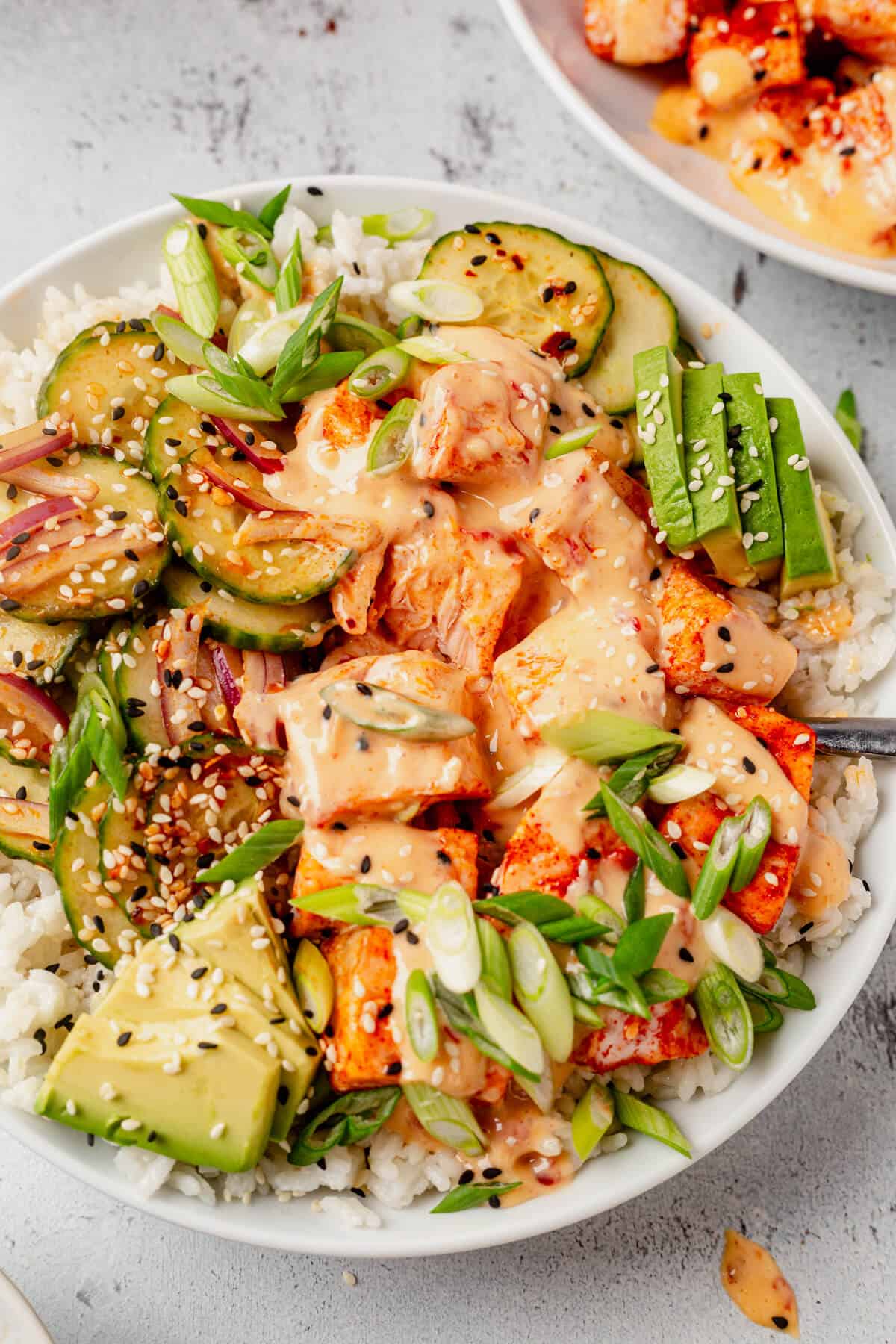 a fork in a bowl of bang bang salmon