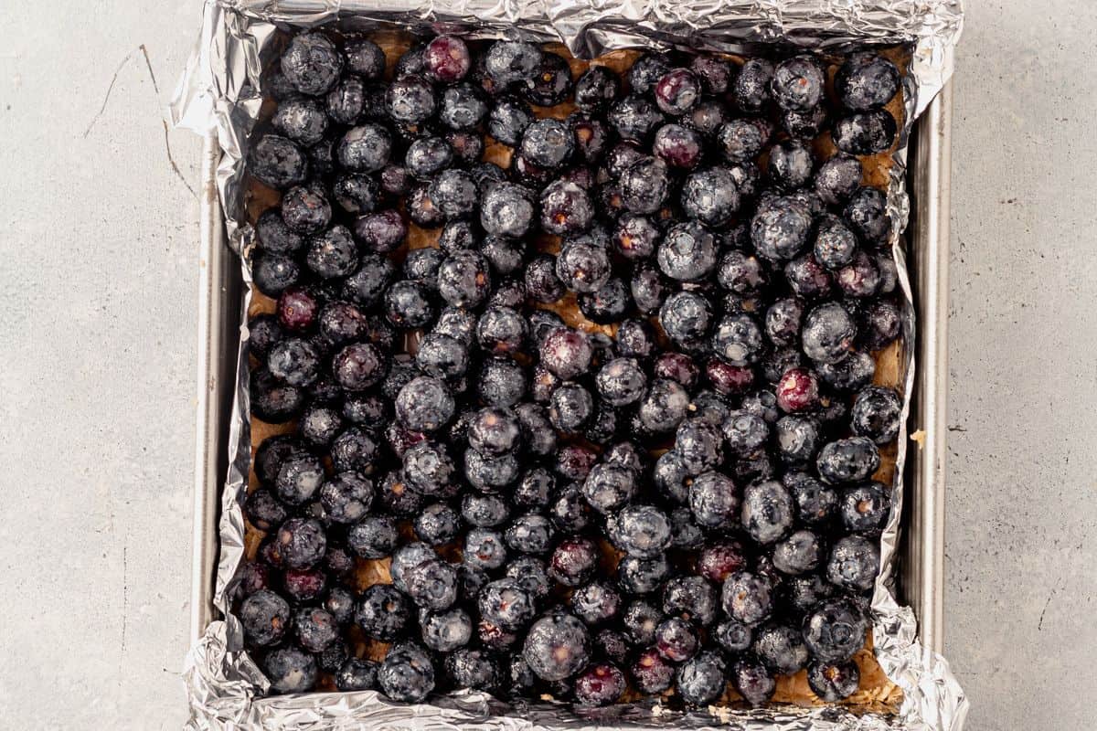 fresh blueberry filling on top of oatmeal crumb dough