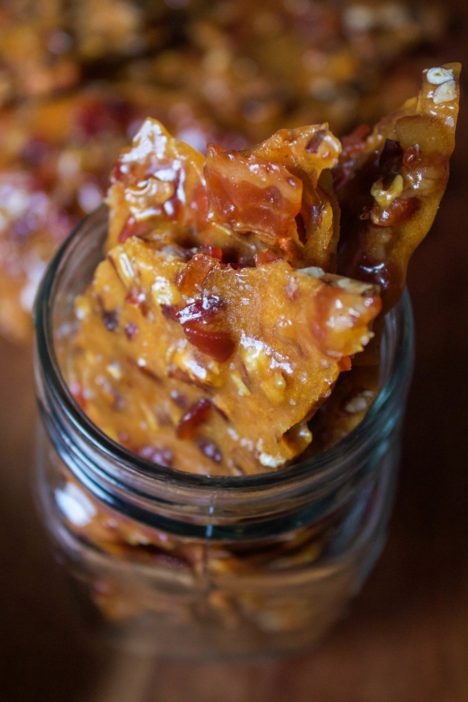 pieces of bourbon bacon brittle sitting in a mason jar