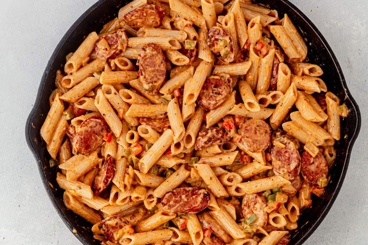 creamy cajun sausage pasta in a skillet