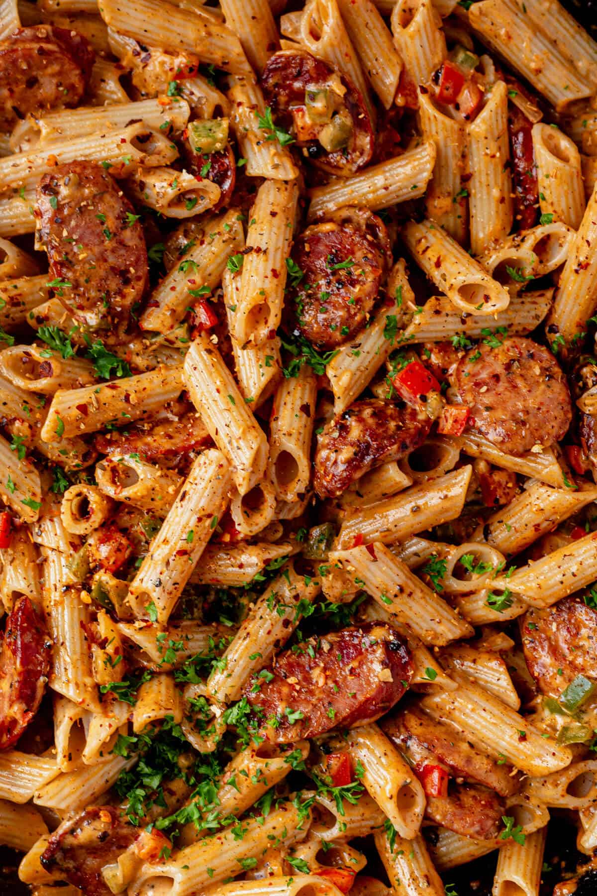 cajun sausage pasta with chopped parsley on top
