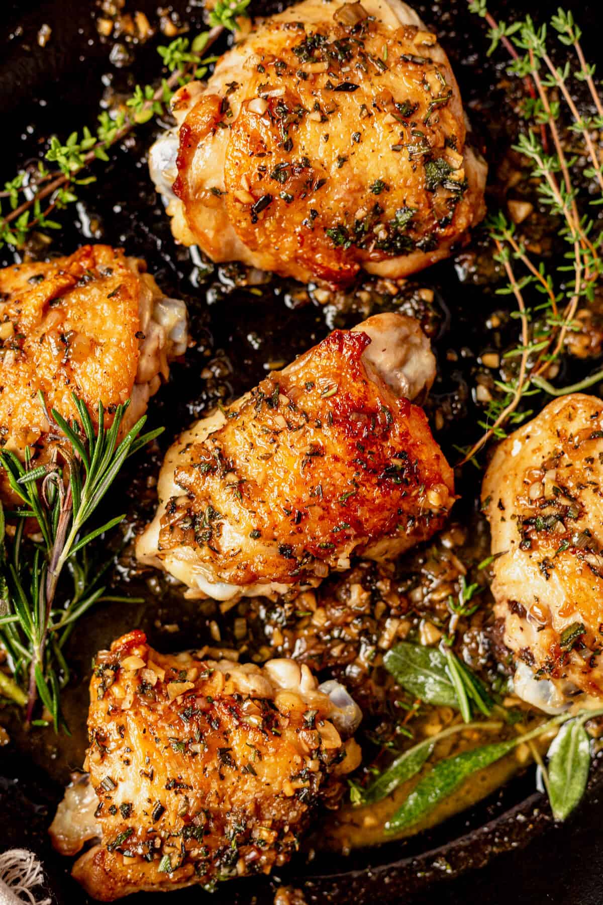 5 crispy golden chicken thighs with skin in a skillet