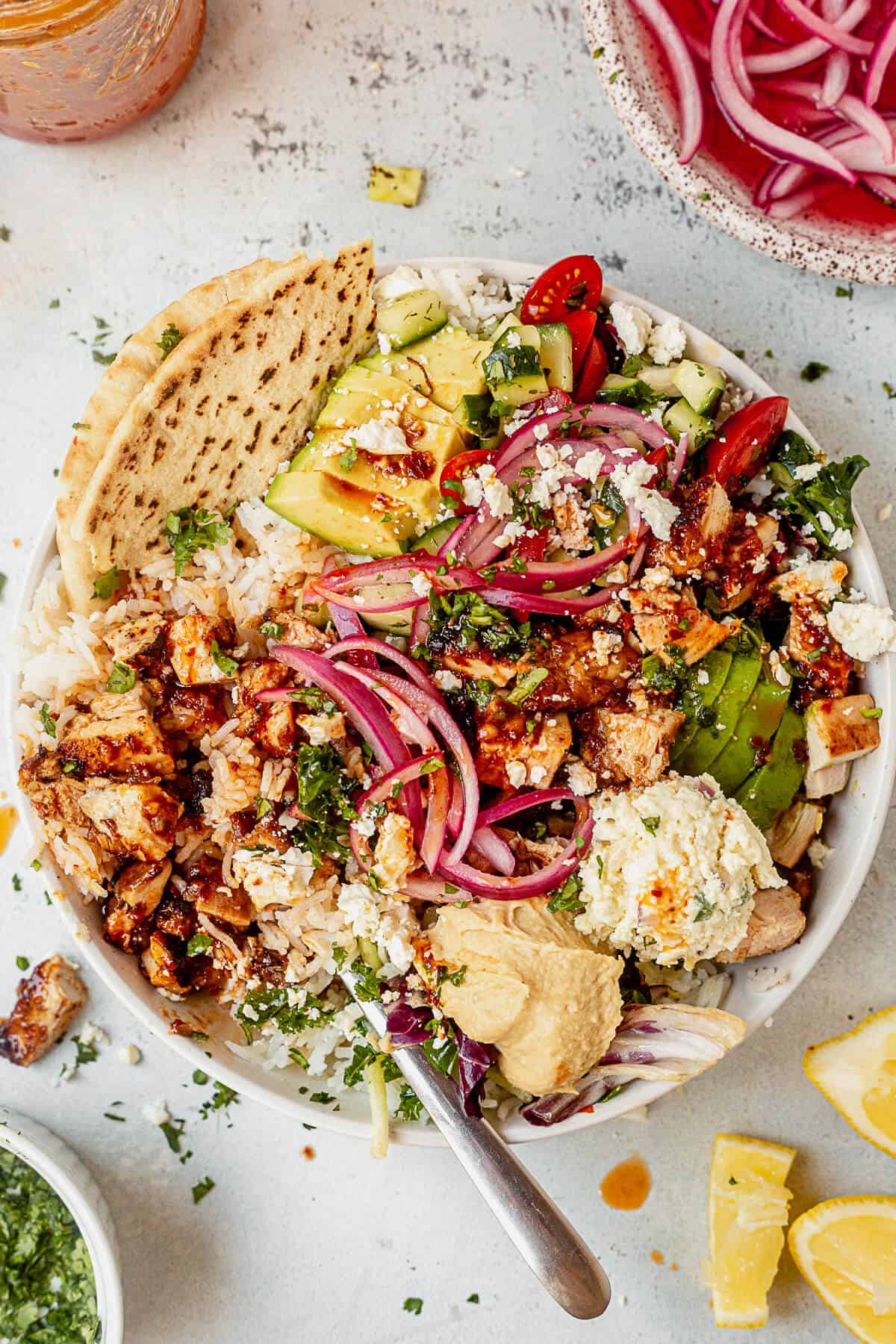 copycat cava honey harissa chicken with avocado, hummus, feta, and pita bread