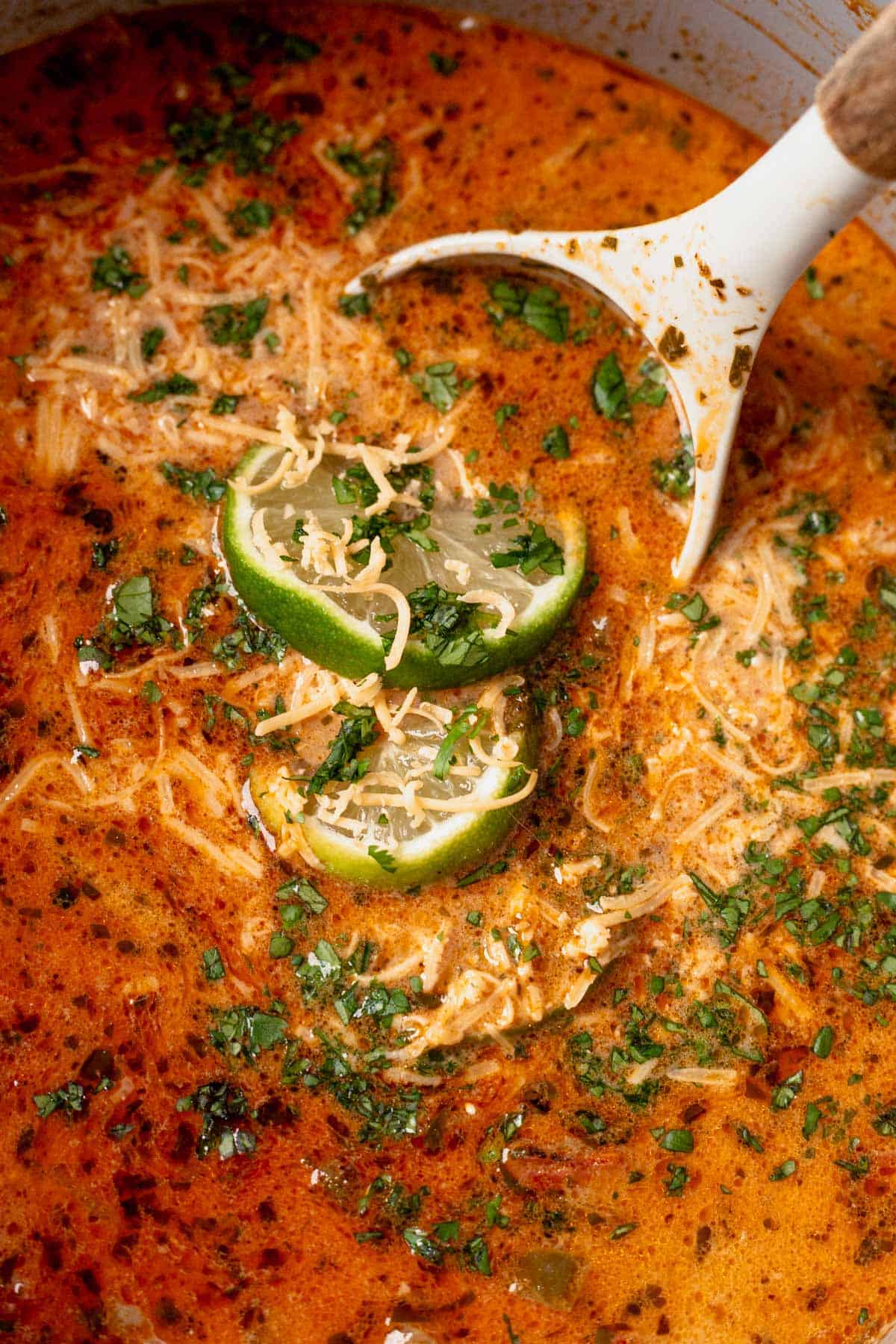 creamy chicken tortilla soup in a pot with a ladle