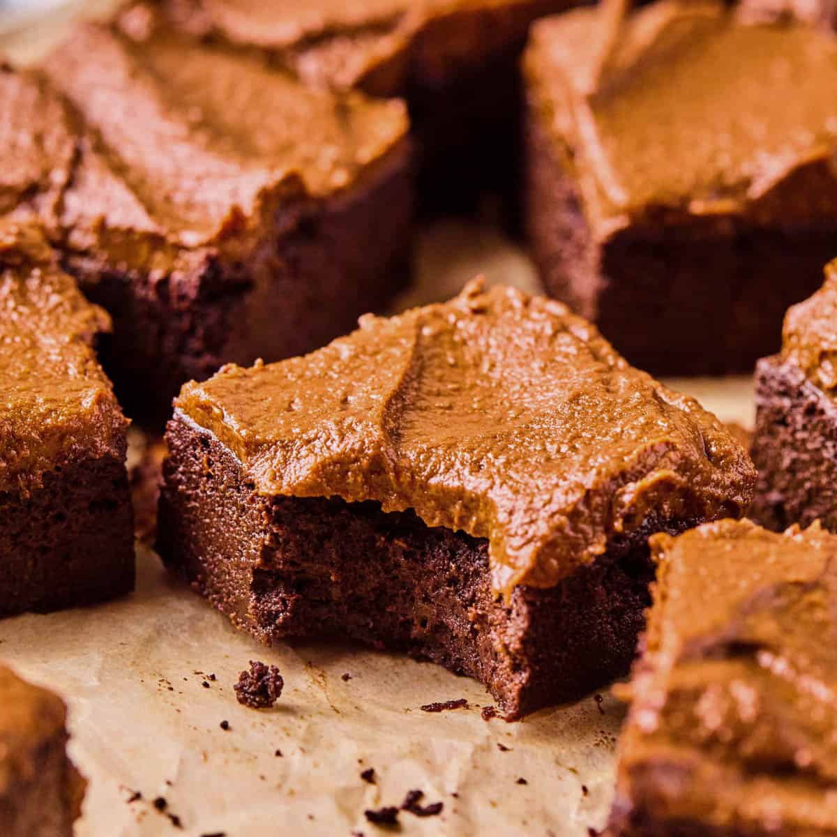 chocolate potato cake cut into square with a bite taken out of one corner.