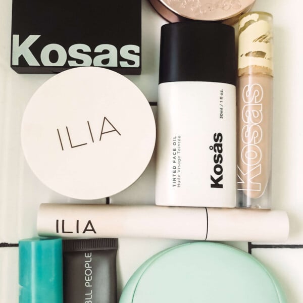 clean beauty brand products laying on white subway tile