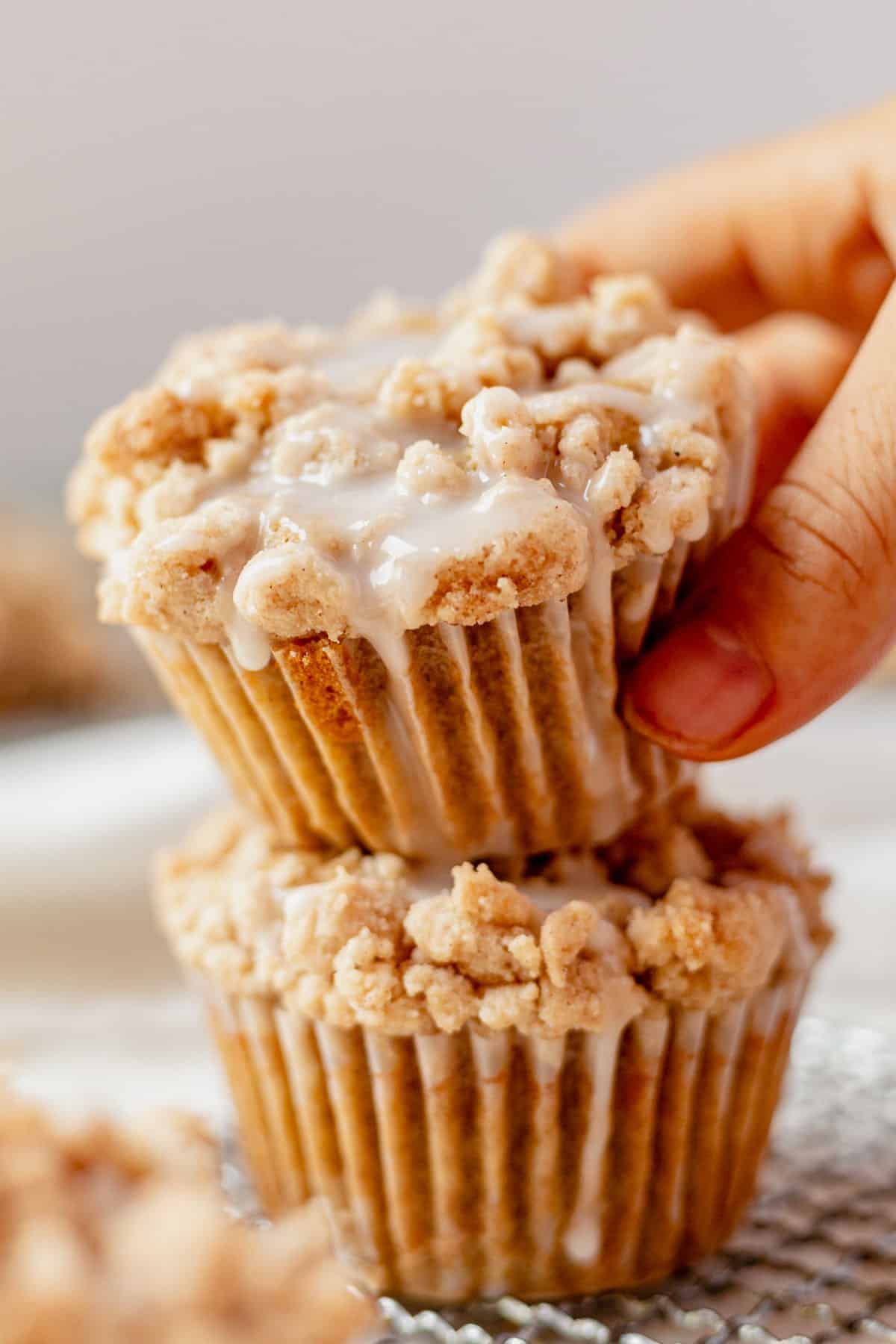 two coffee cake muffins stacked on a countertop