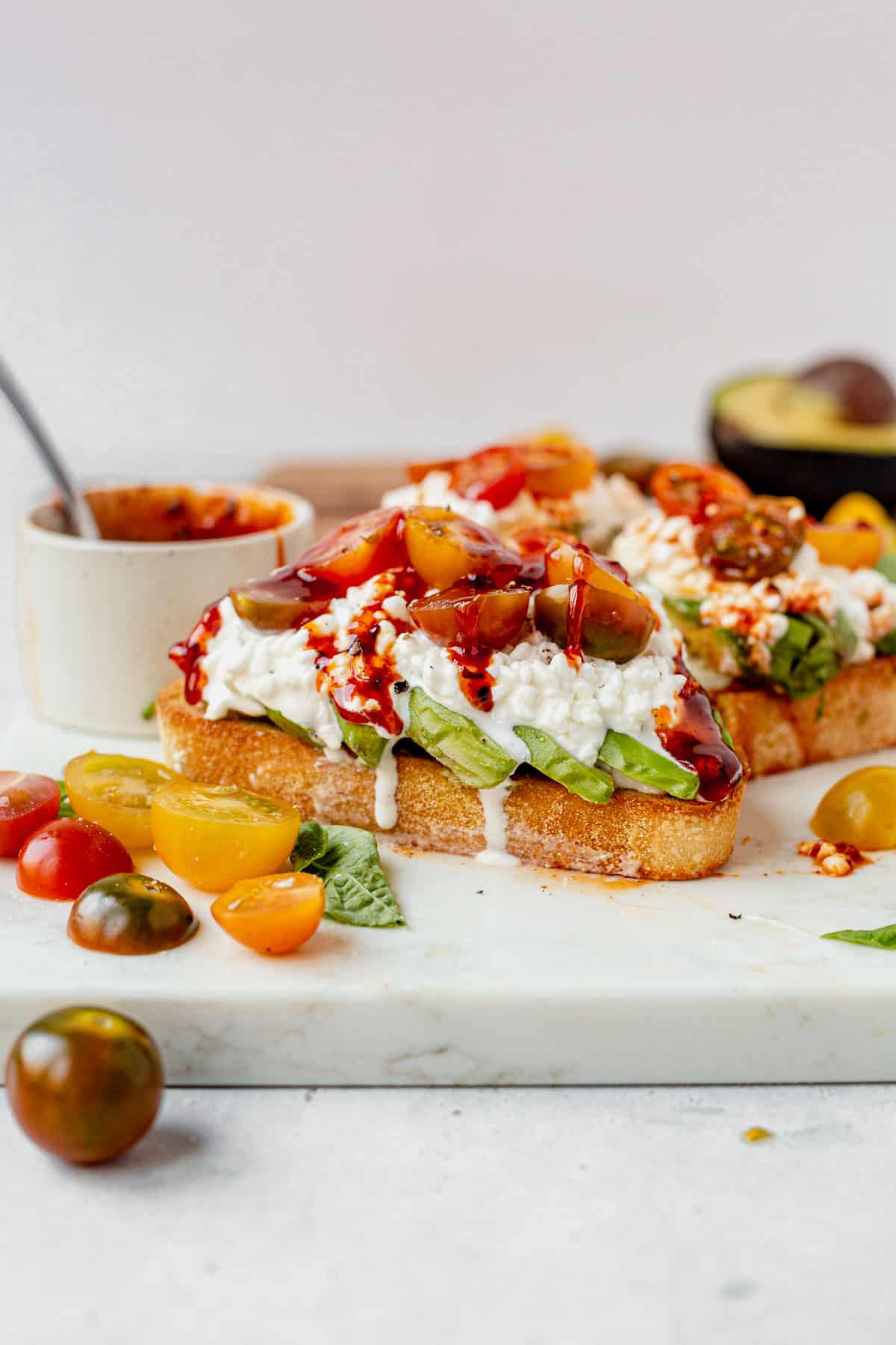 avocado, tomatoes, and cottage cheese on top of toast