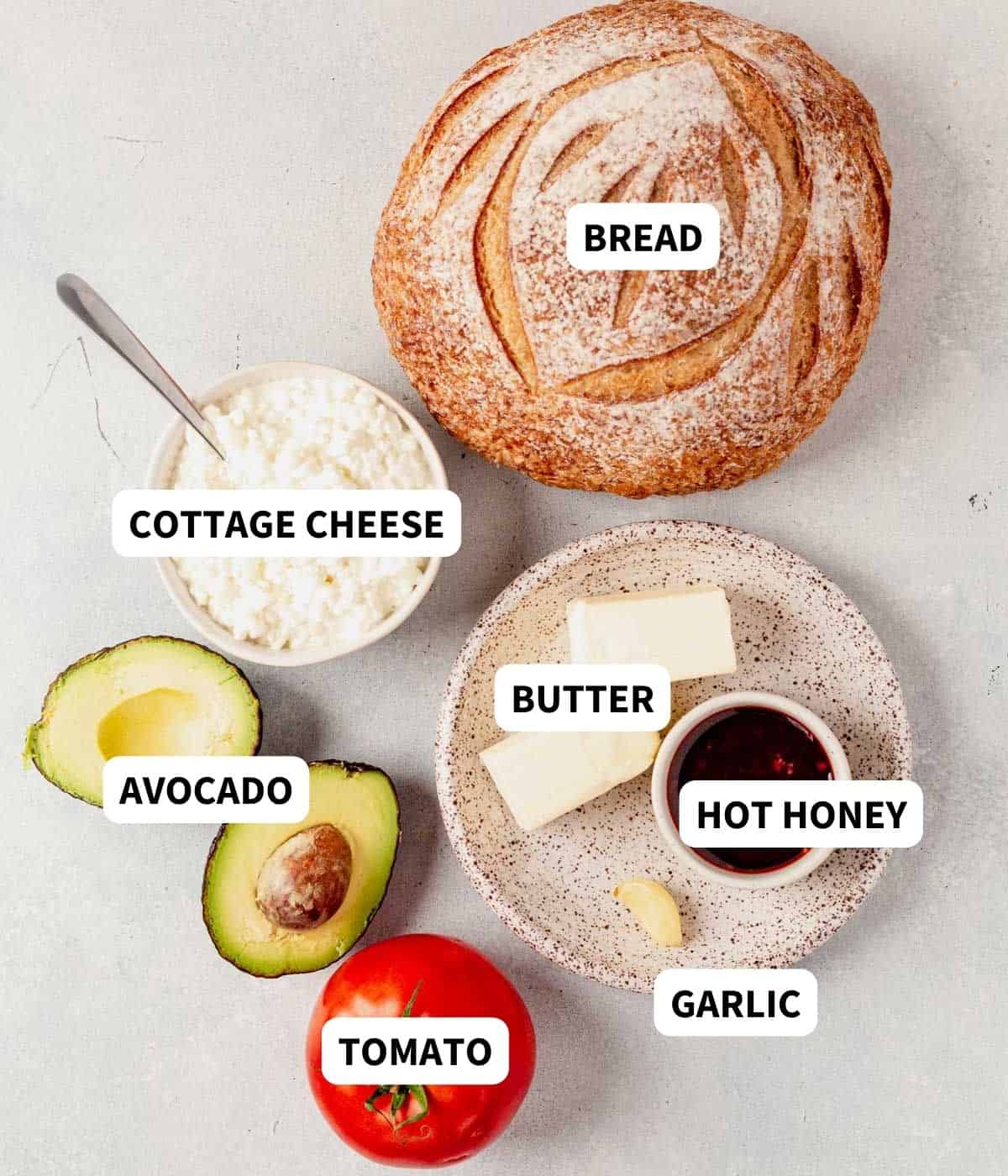 sourdough, cottage cheese, avocado, and tomato on a contertop