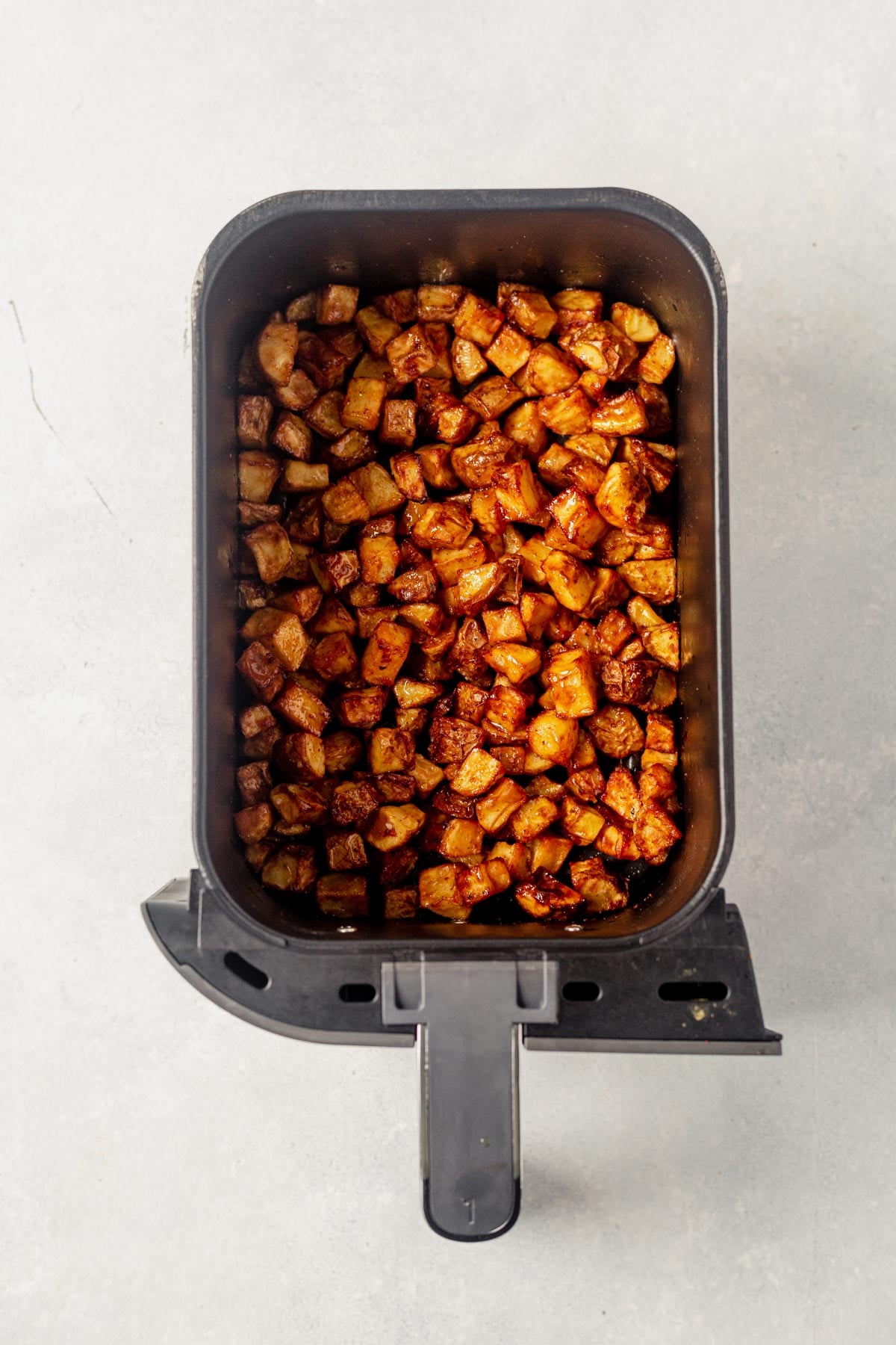 crispy cooked air fryer breakfast potatoes in an air fryer basket