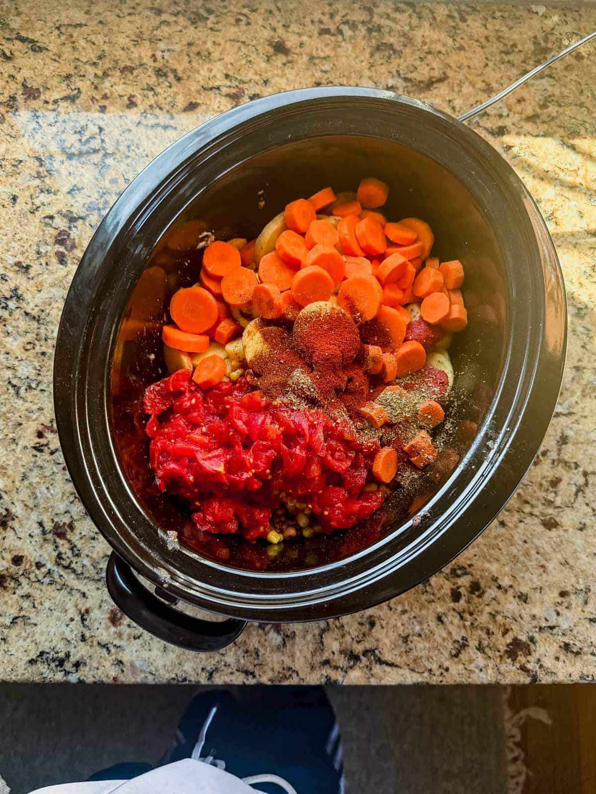 cowboy casserole ingredients in a crock pot.
