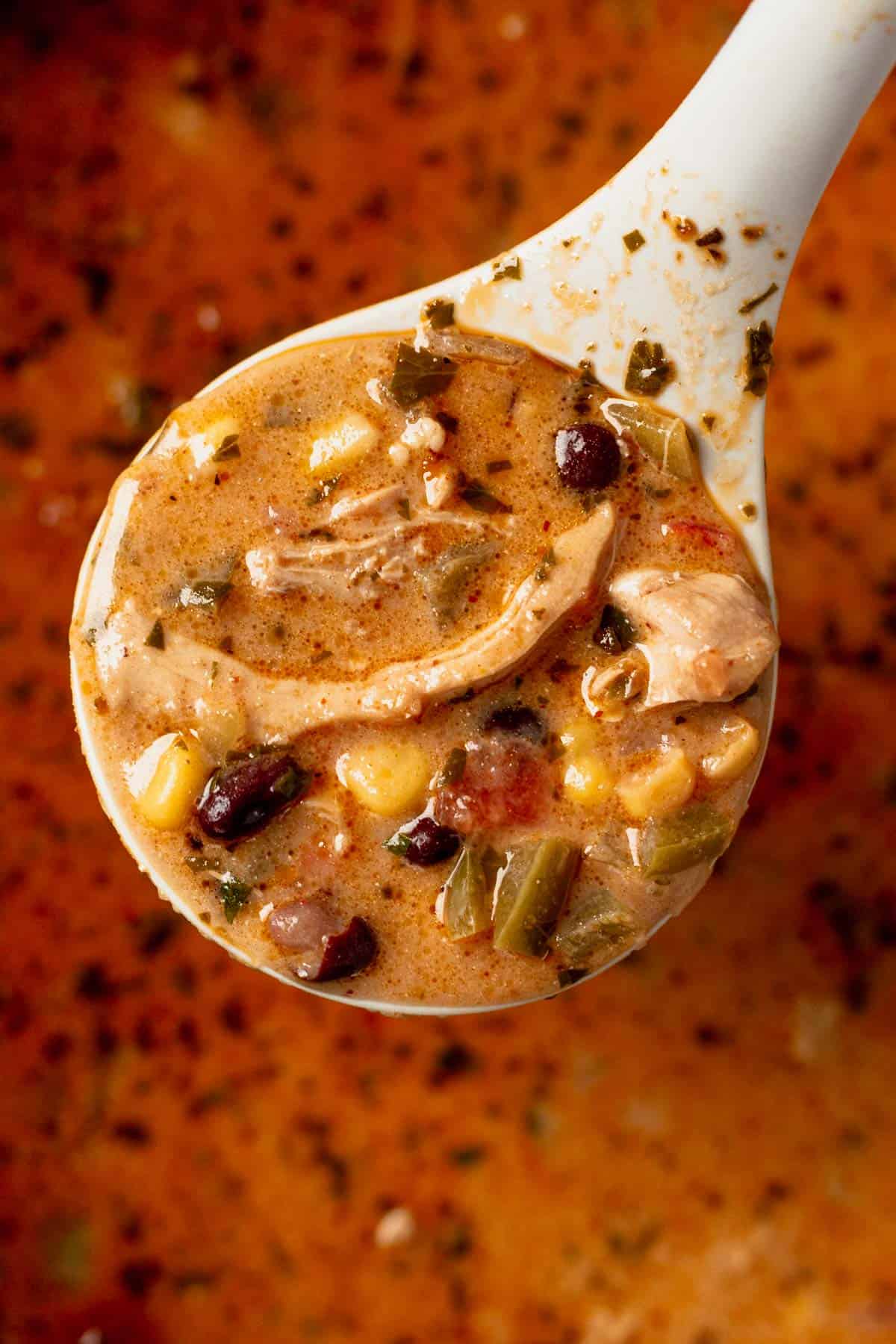 a ladle full of creamy chicken tortilla soup