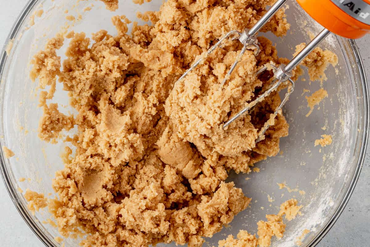 edible cookie dough in a mixing bowl with electric mixer