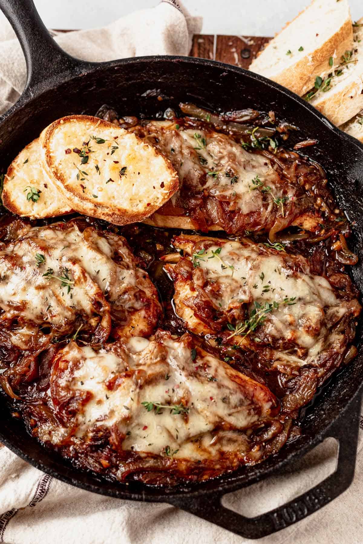 french onion chicken bake in a cast iron skillet