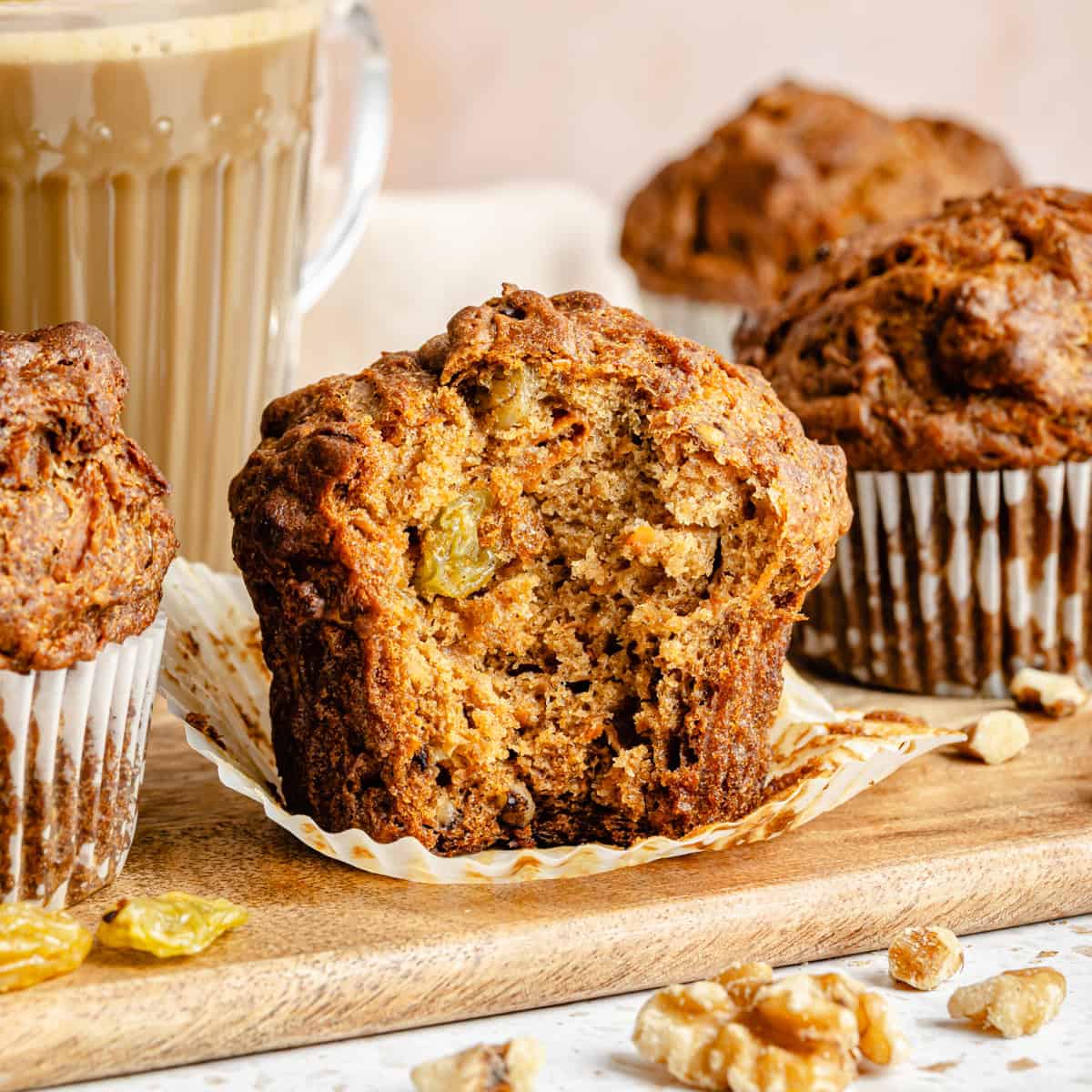 gluten free morning glory muffin on a cutting board with a bite taken out.