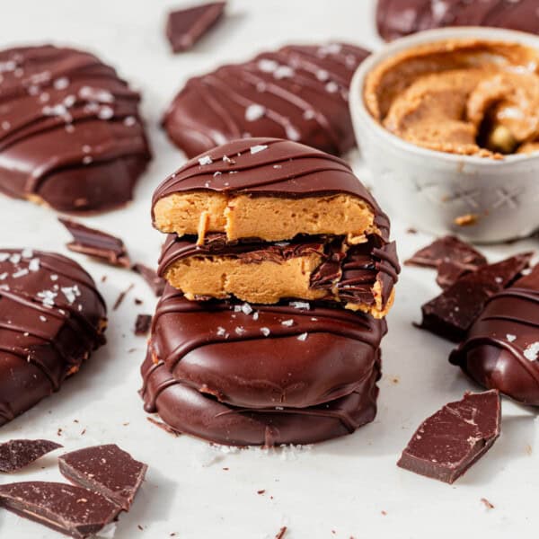 homemade healthy reeses eggs stacked on a counter.