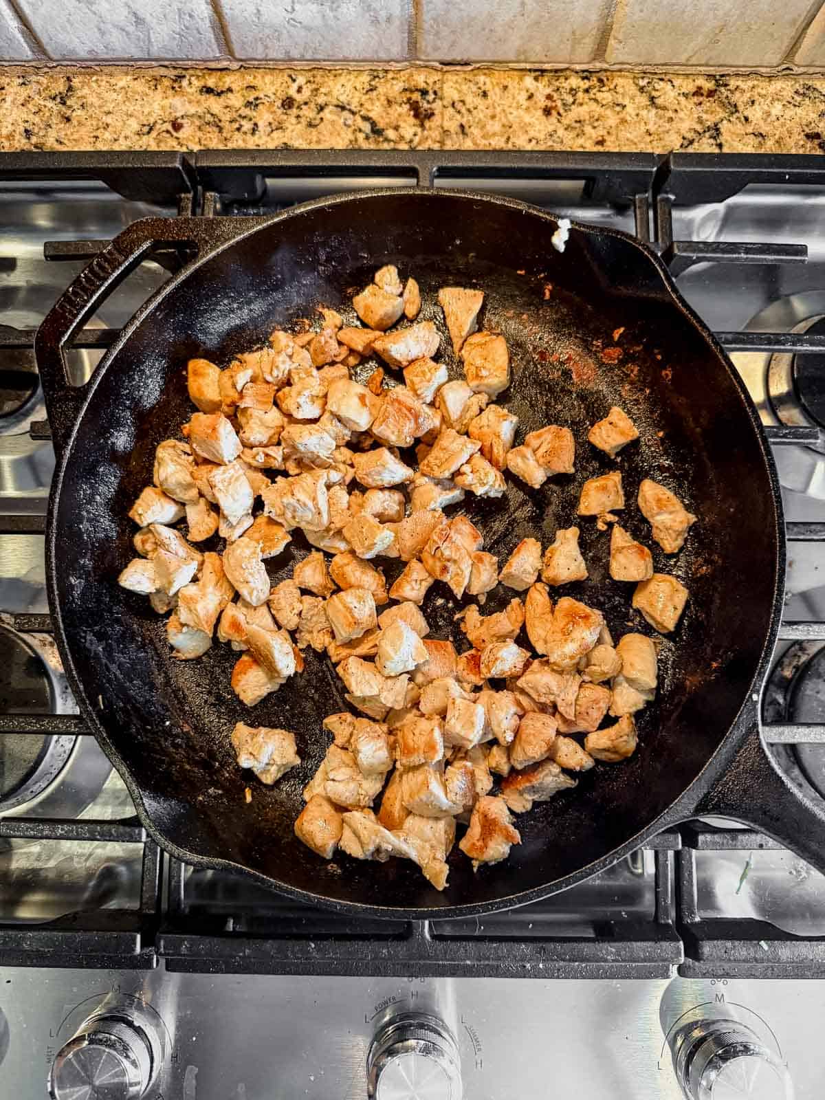 cooking chicken pieces in a skillet until golden brown and crispy.
