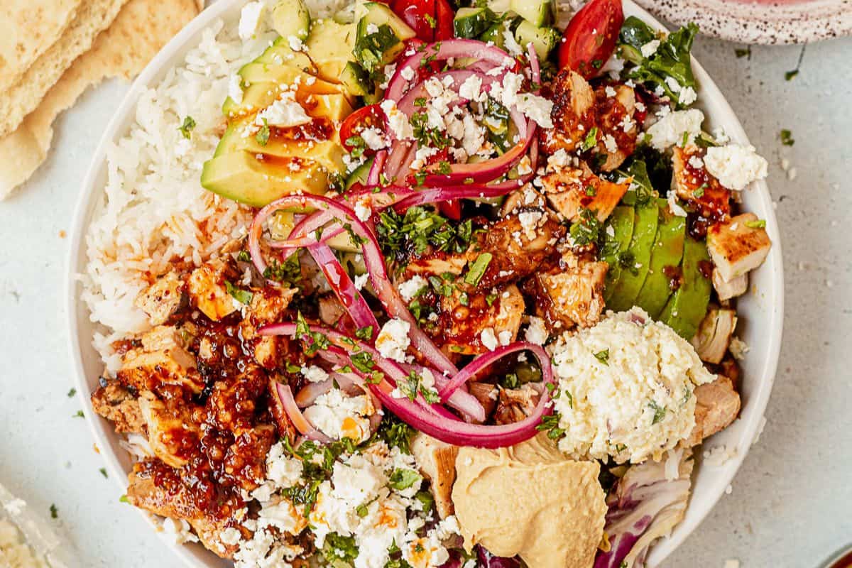 copycat cava honey harissa chicken with pickled onion, feta, avocado, and herbs