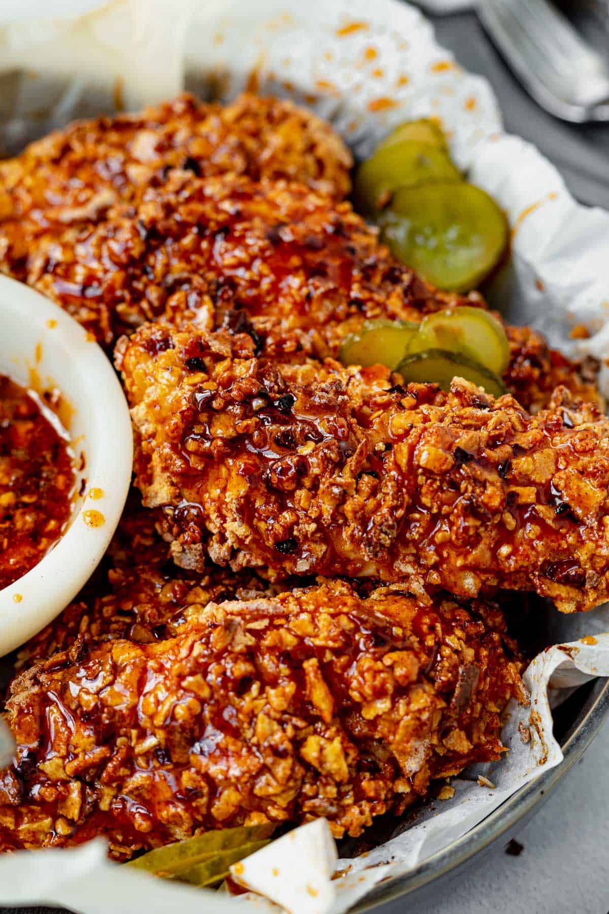 honey honey chicken tenders in a basket with parchment paper