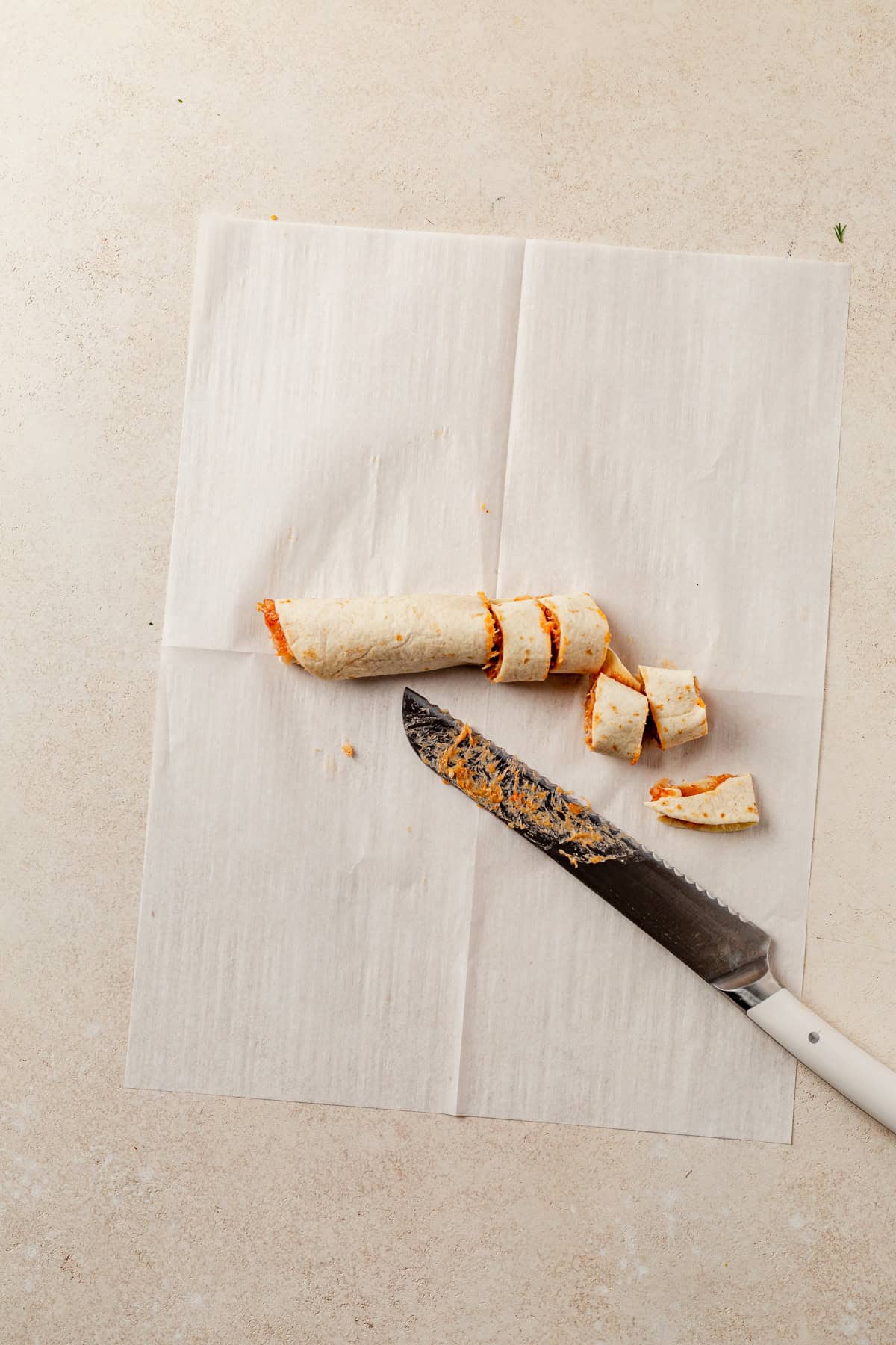 slicing lazy kebab rolls on a counter.