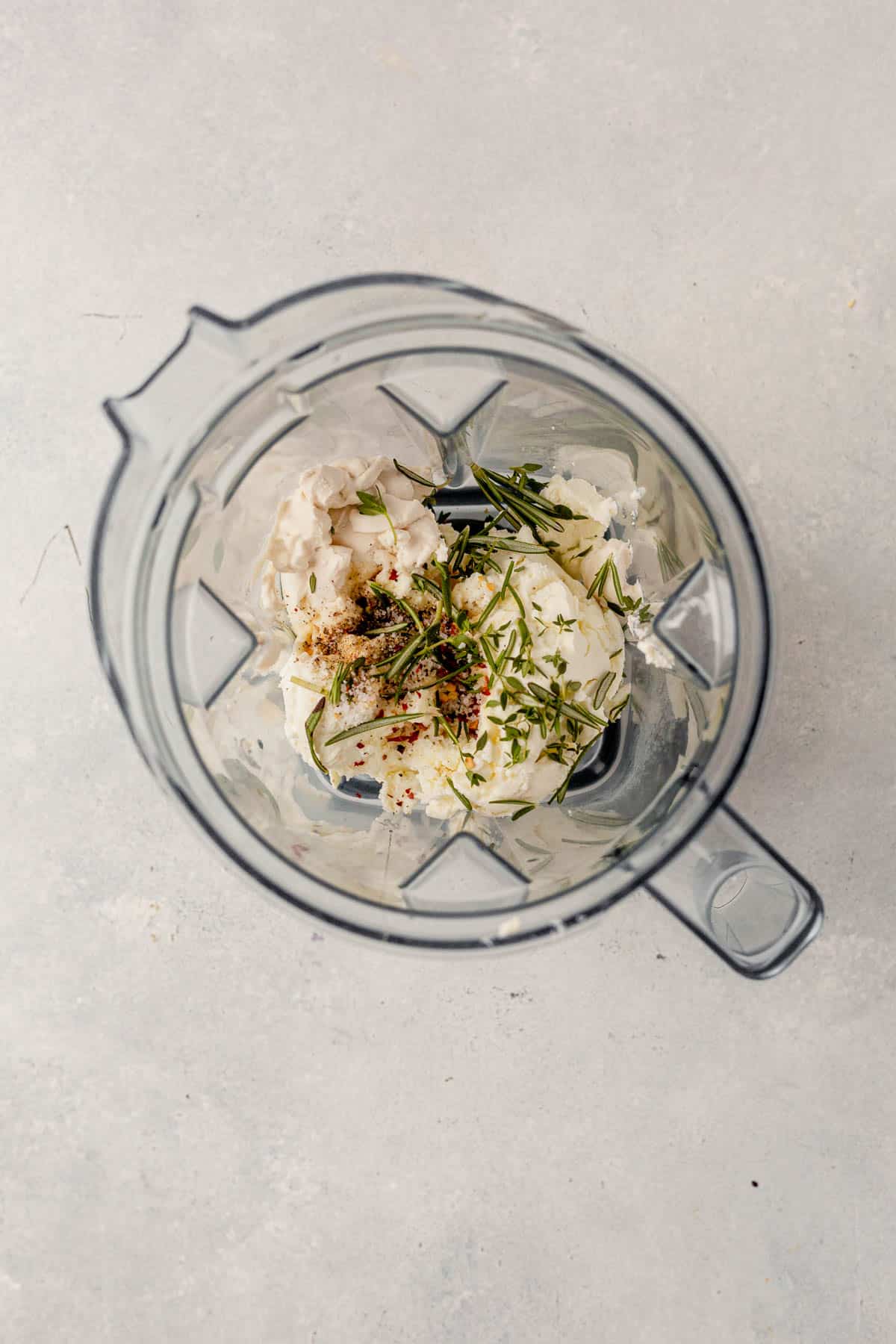 goat cheese, olive oil, herbs, and salt in a blender.