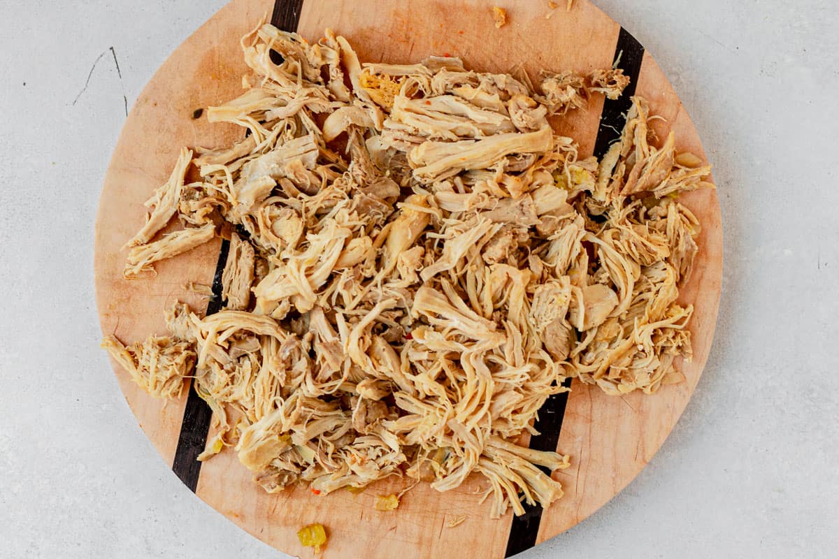 shredded chicken on a cutting board