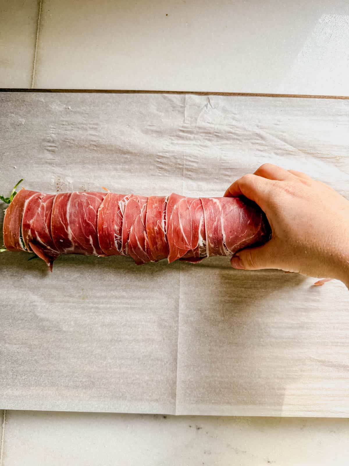 proscuitto rolled up around antipasto ingredients.