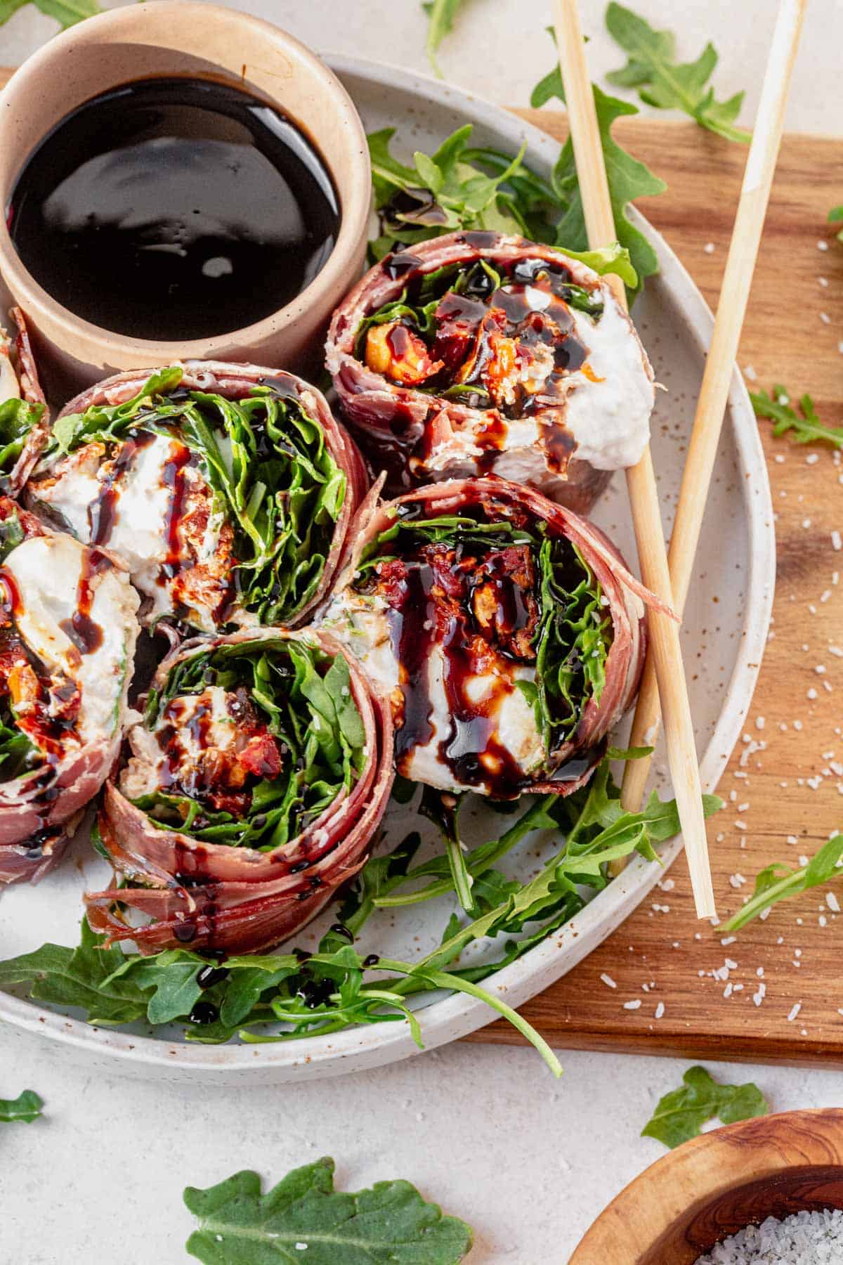italian sushi slices on a serving plate with balsamic glaze.