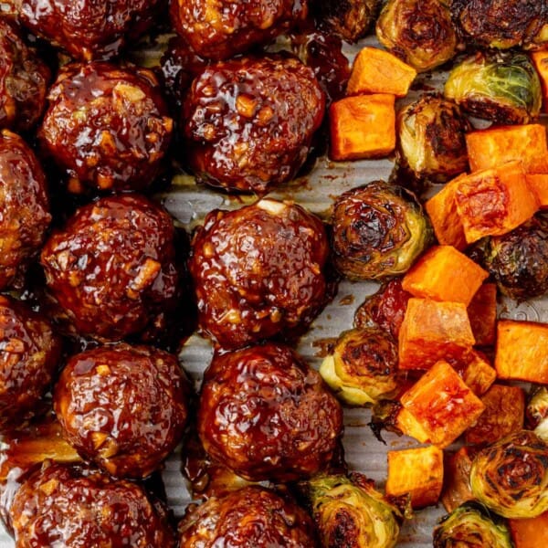 korean bbq meatballs baked on a sheet pan with vegetables.