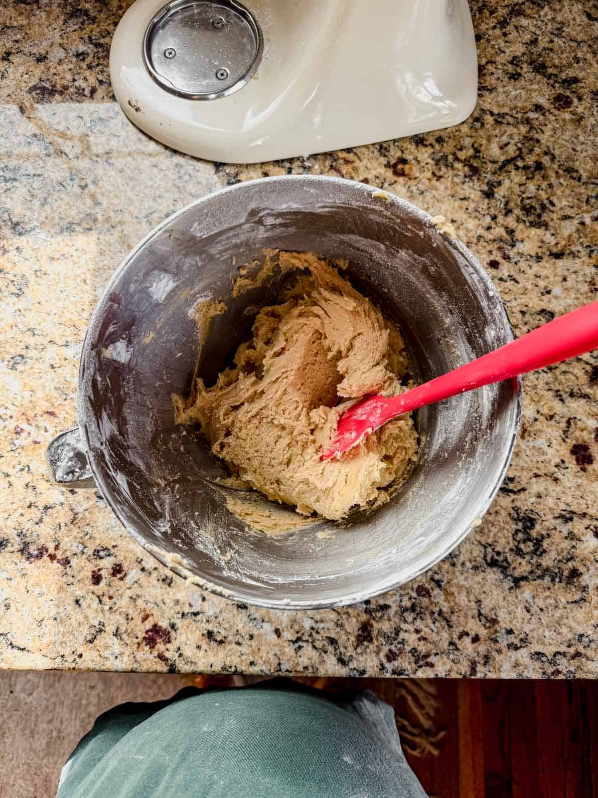 mint oreo cookie dough in a mixing bowl with a rubber spatula.