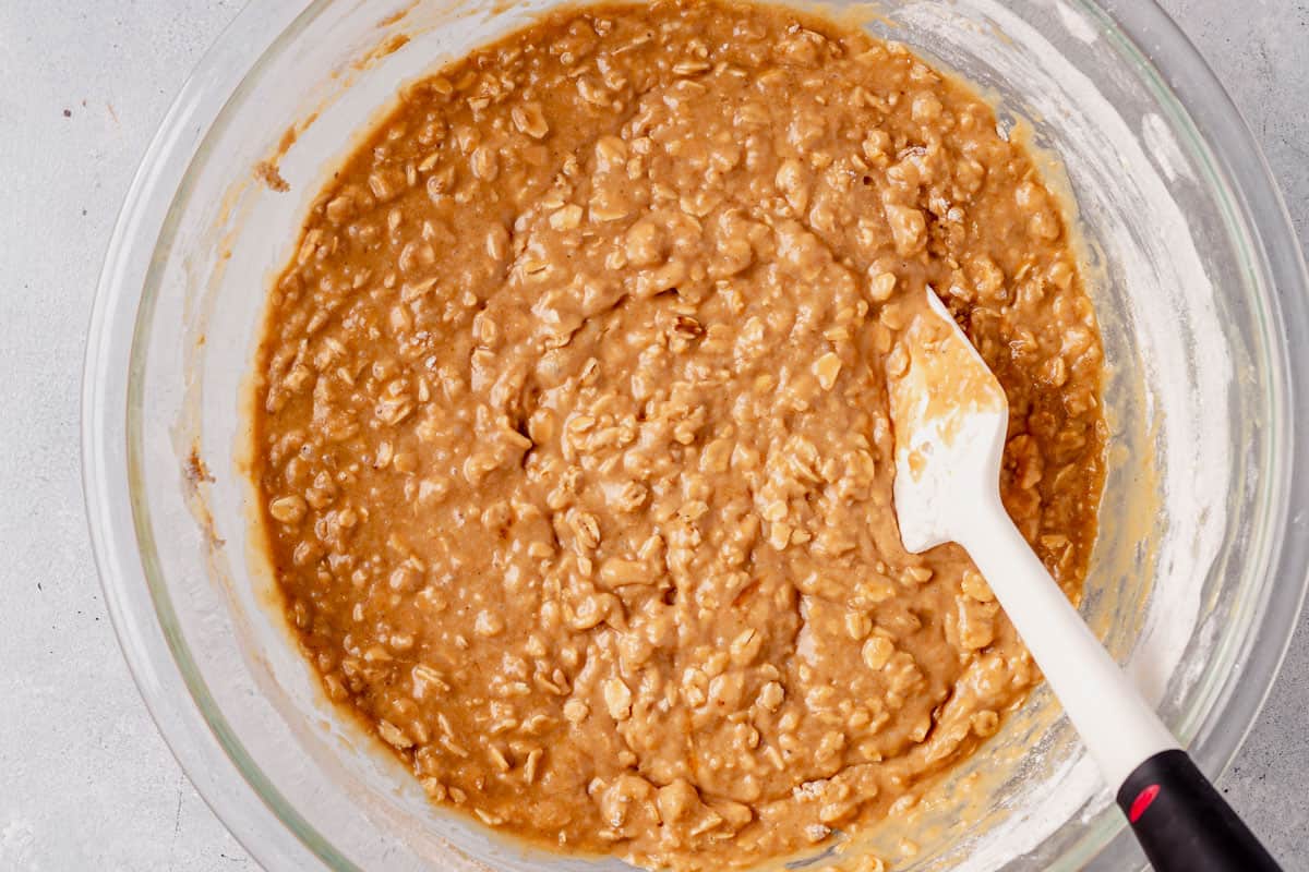 oatmeal muffin batter with a rubber spatula in a bowl