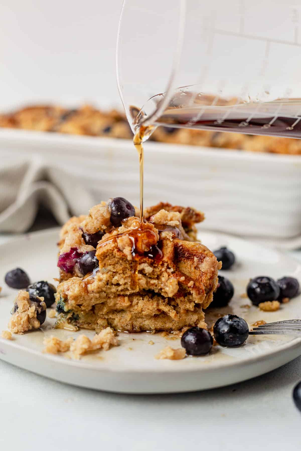 syrup pouring on top of waffle casserole