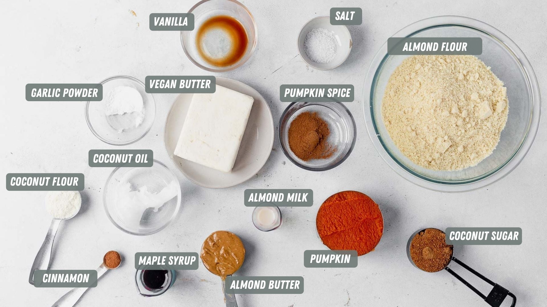 Paleo bars filled with pumpkin and spice! These little squares of heaven taste just like pumpkin pie! And they're paleo:) Which means they're gluten-free, refined sugar free and dairy free. They taste like fall in a bite and are topped with a light maple frosting you will be drooling over. ingredients for paleo pumpkin bars measured out on a table