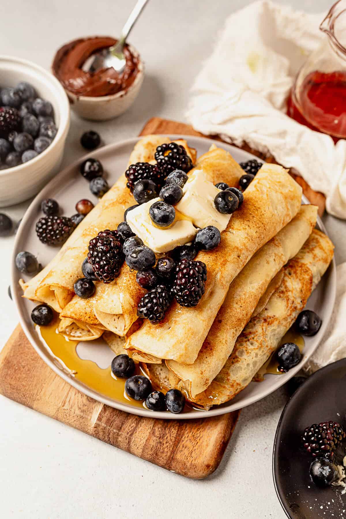 syrup covering a stack of pancake roll ups