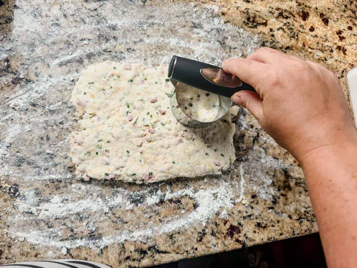 cutting protein biscuits out of the dough with a biscuit cutter.