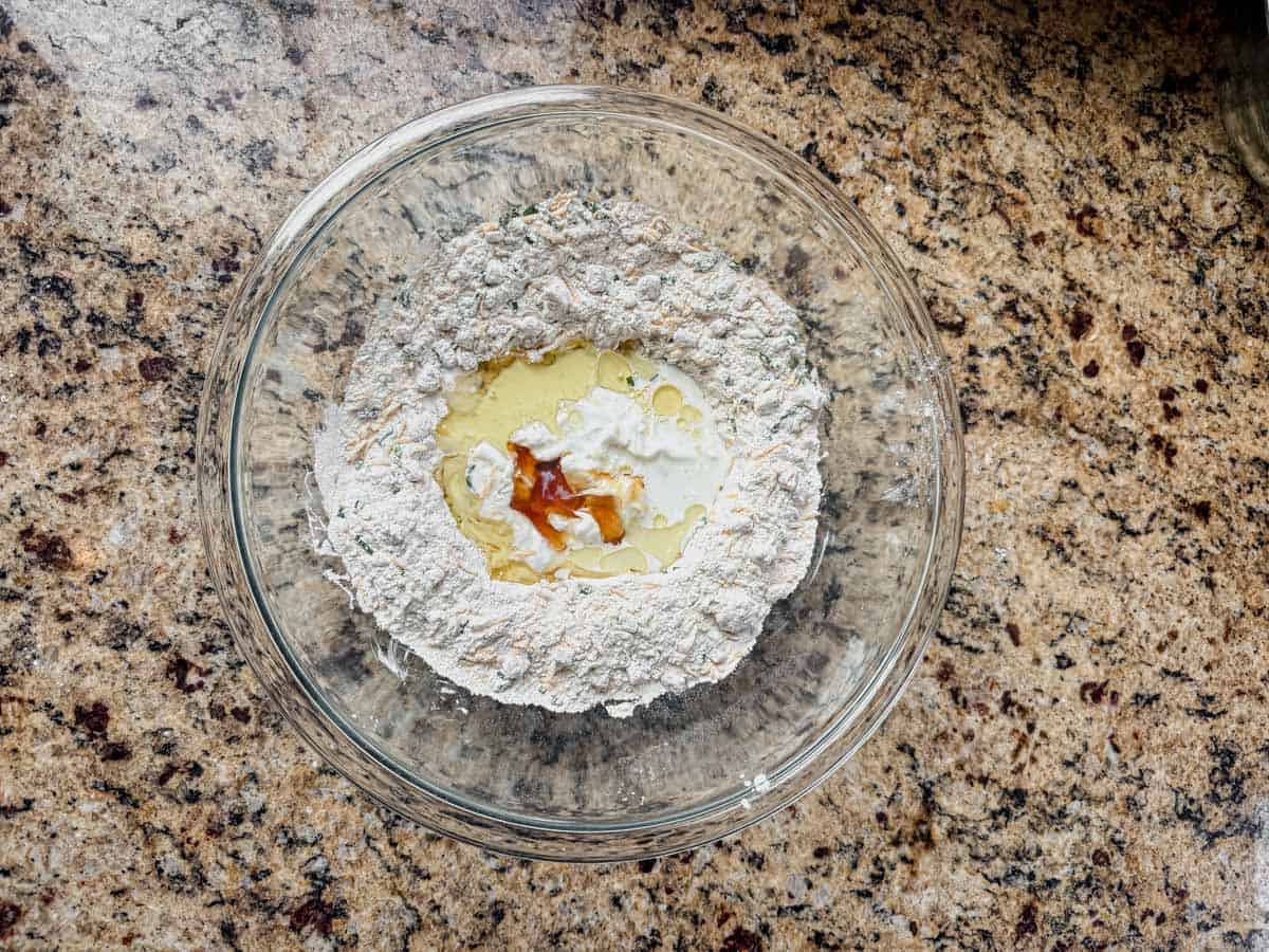 whisking the wet ingredients into protein biscuit dough.