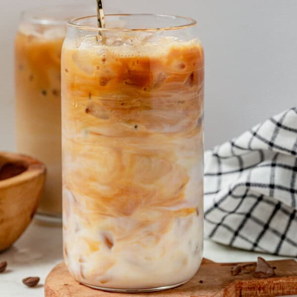mixing a protein coffee in a glass with ice.