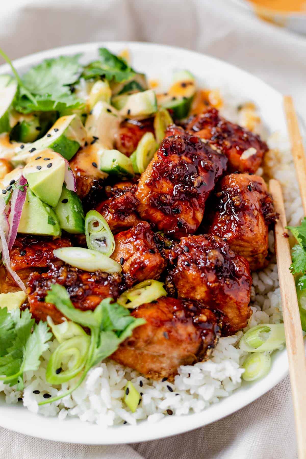 salmon rice bowl with honey garlic sauce, cucumber and avocado