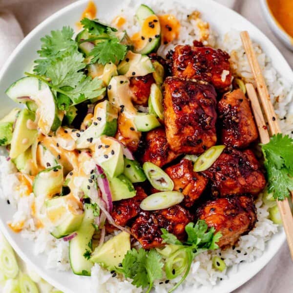 salmon rice bowl with cucumber, avocado, cilantro and honey garlic sauce