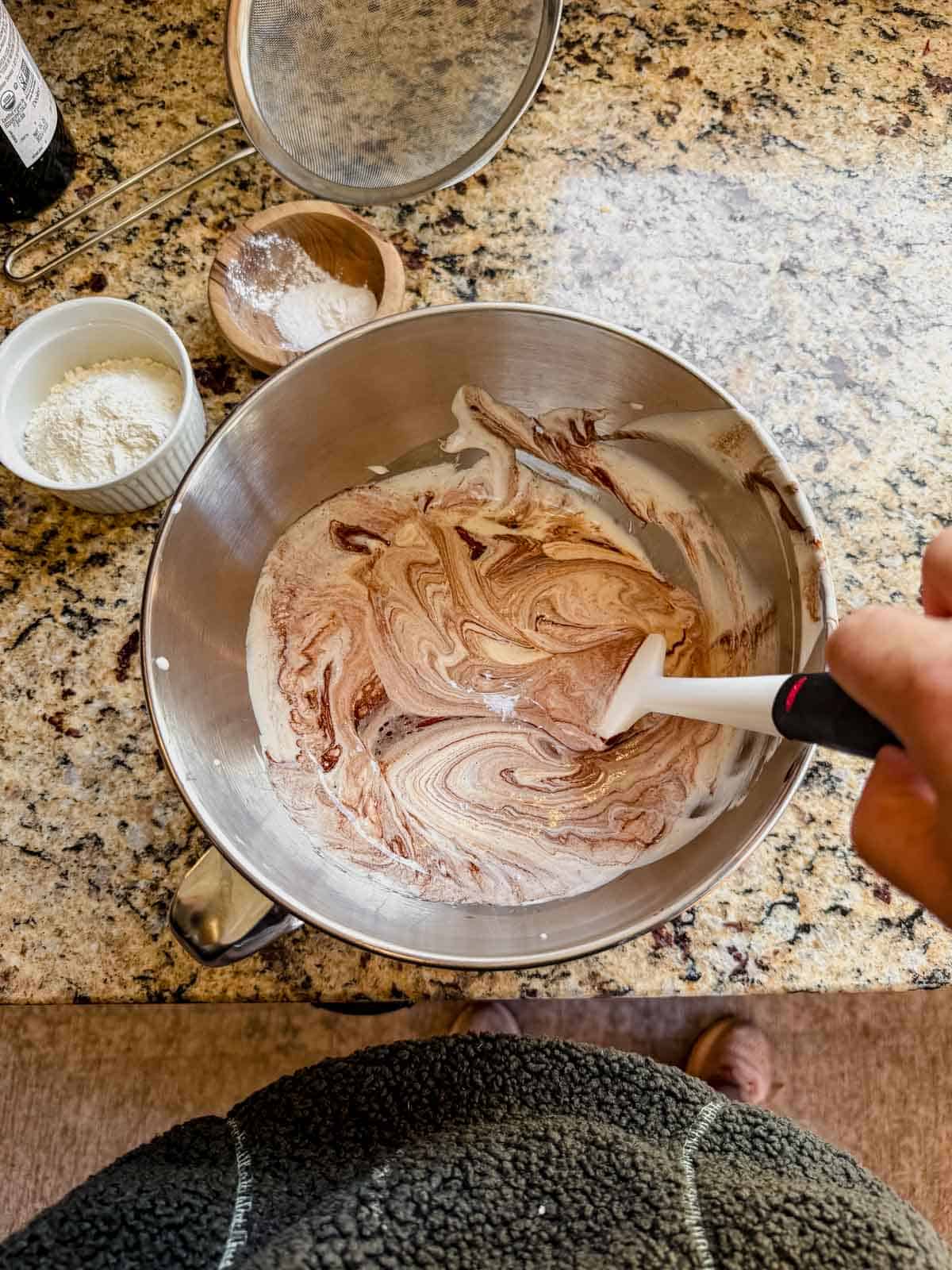 saptula mixing cocoa powder into batter