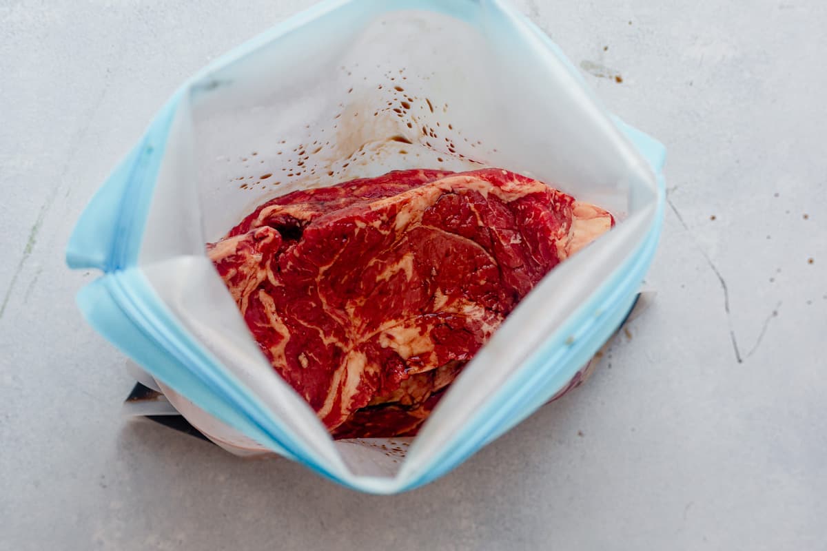 steak marinating in a freezer bag.