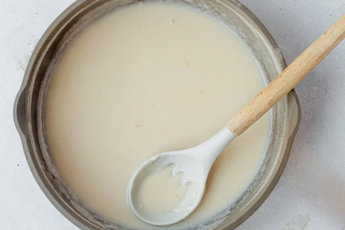 creamy alfredo sauce in a skillet.