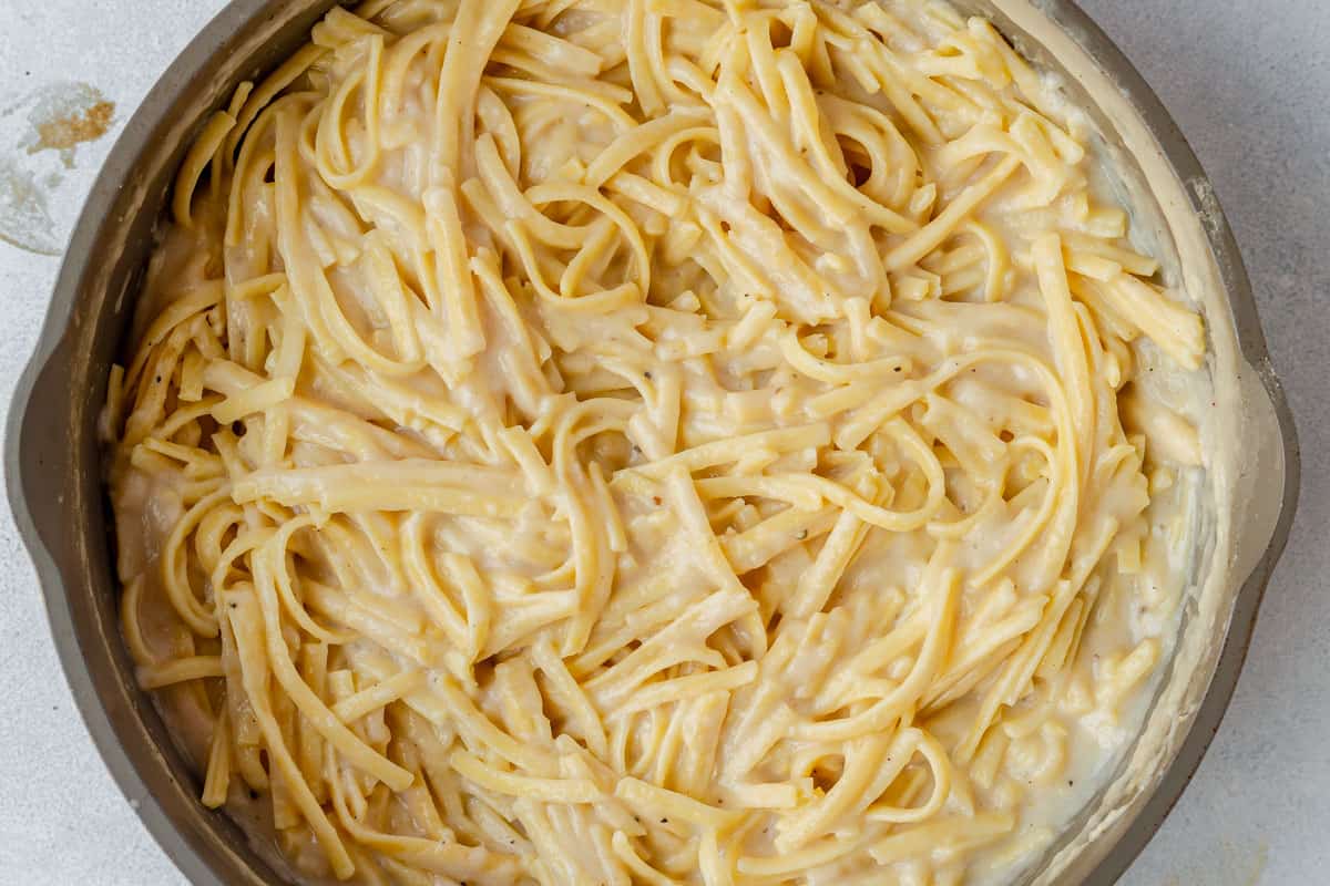 creamy alfredo sauce tossed with fettuccine in a pan