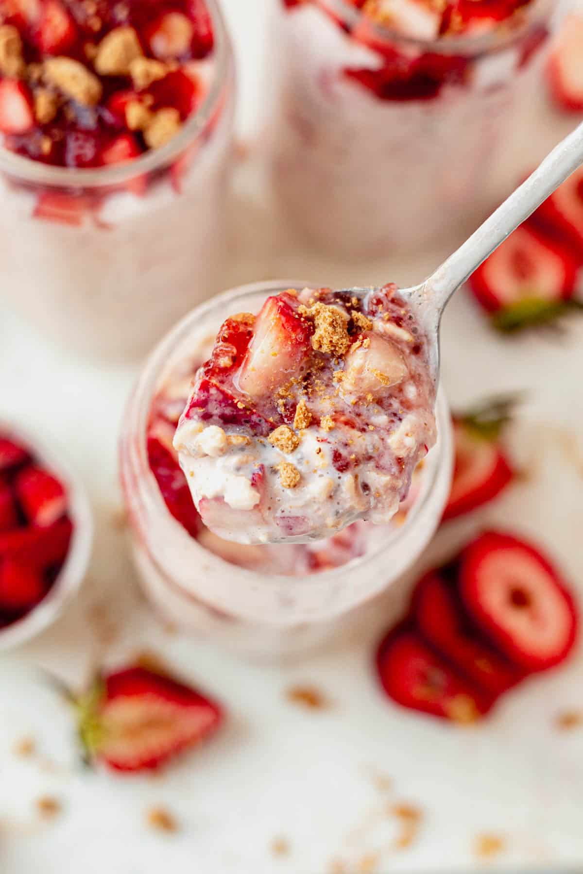 scooping overnight oats out of a jar